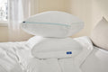 Two Original Cooling Pillows stacked on top of each other on a bed