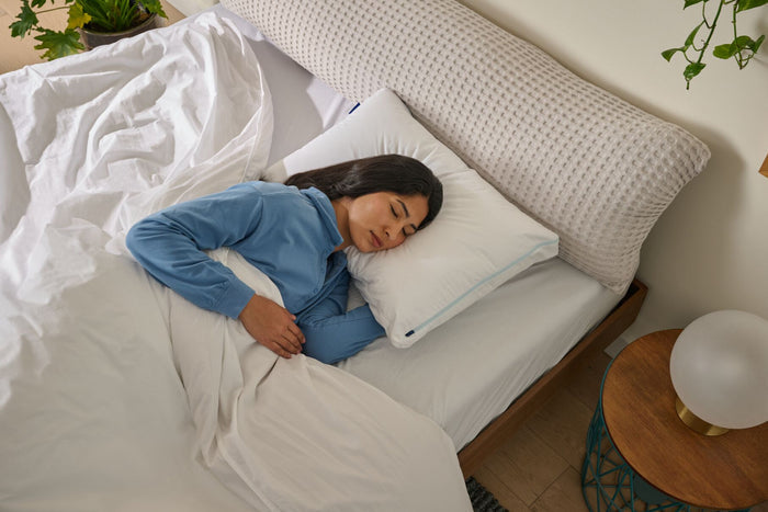 Overhead view of a woman sleeping in bed on a Original Cooling Pillow