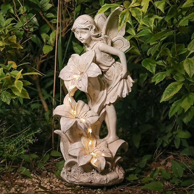 Outdoor solar angel statue with fairy girl holding flowers, lit LED accents, resin look