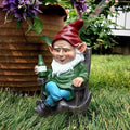 Garden gnome figurine with red hat, white beard, green vest, holding a wine bottle