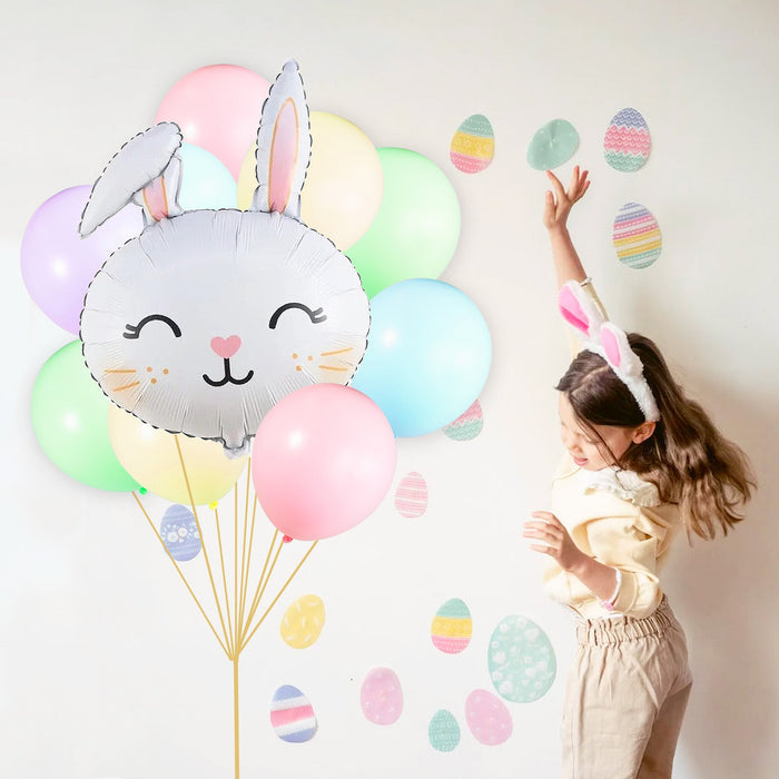 Gray bunny balloon bouquet with pastel balloons and a child reaching for floating balloons