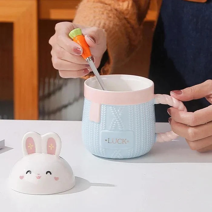 Blue bunny ceramic mug with rabbit lid, textured body, and 'LUCK' text.