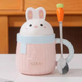 Pink bunny ceramic mug with rabbit lid, textured body, and 'LOVE' text.