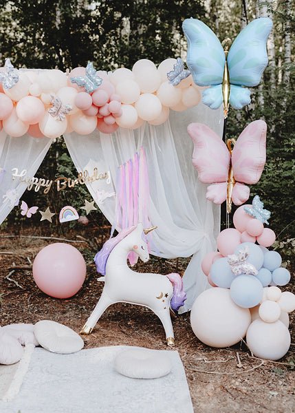 Pastel butterfly balloon garland with large blue, pink, and white butterfly balloons