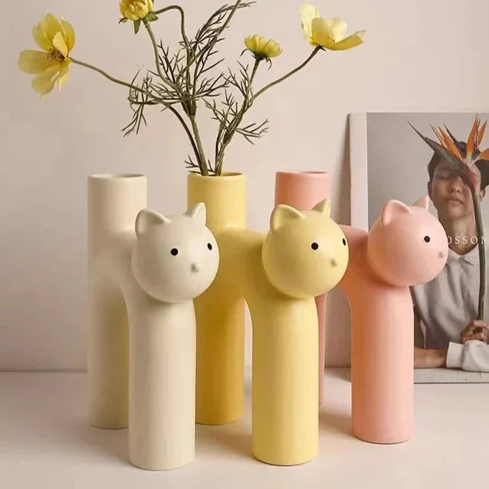 Set of pastel ceramic cat flower vases in cream, yellow, and pink colors, tall stems