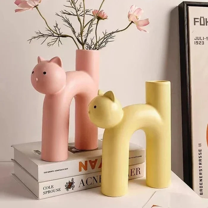 Pastel cat ceramic flower vases in pink and yellow, with cat-head silhouettes