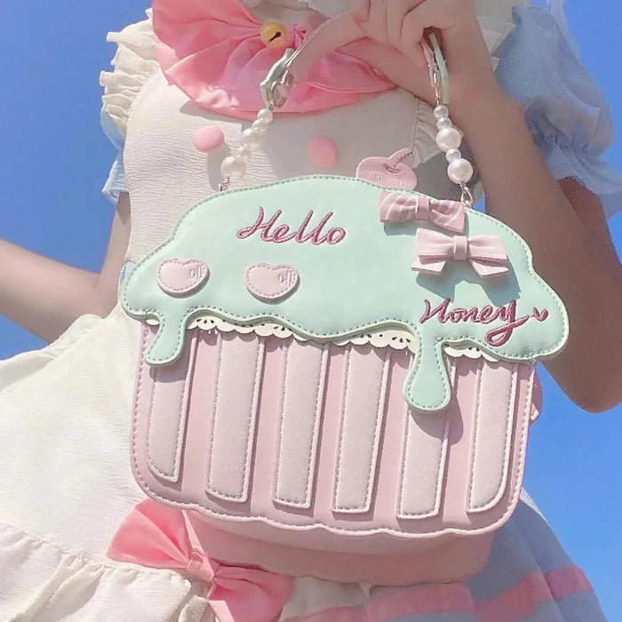 Cupcake-shaped bag with mint top, pink striped bottom, 'Hello' and 'Money' embroidery
