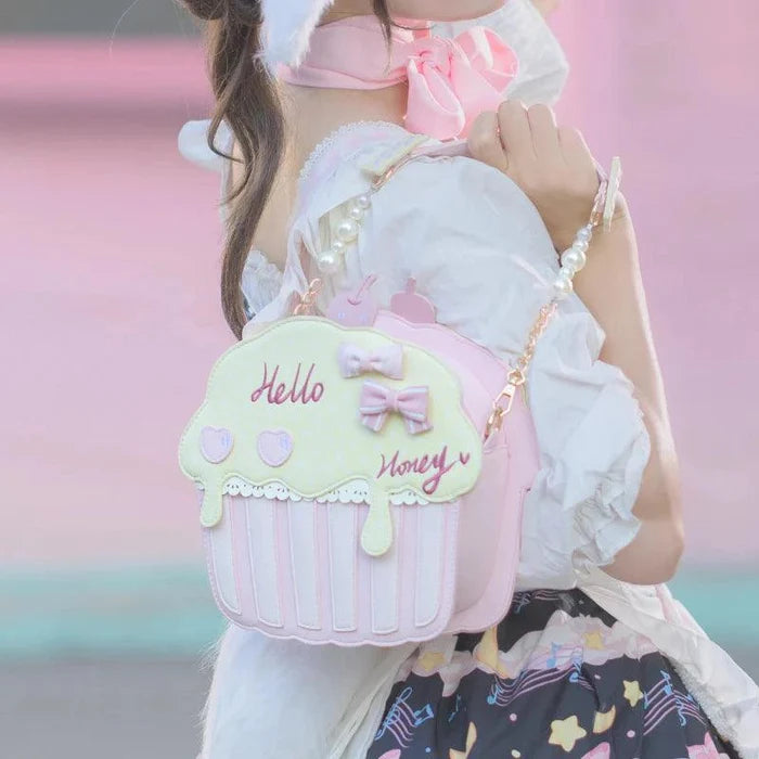 Cupcake-shaped bag with light mint top and white/pink striped base, bow and 'Hello' script