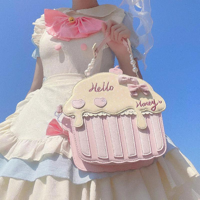 Cupcake-shaped bag with cream top and pink striped bottom, 'Hello' and 'Money' text