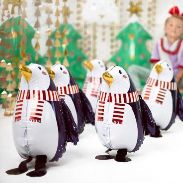 Set of penguin foil balloons, white bodies with navy wings and red striped scarves