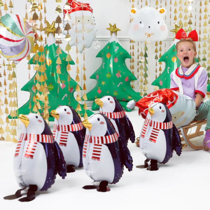 Group of penguin foil balloons with navy wings and red striped scarves