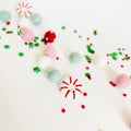 Peppermint felt ball garland with red, pink, mint and white felt balls on a string