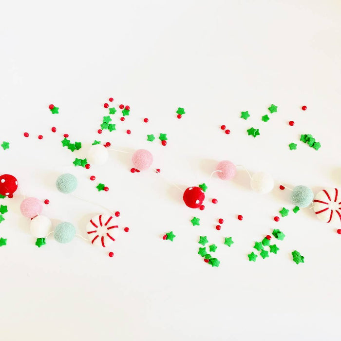 Peppermint felt ball garland laid flat with red, green, mint, pink and white felt balls