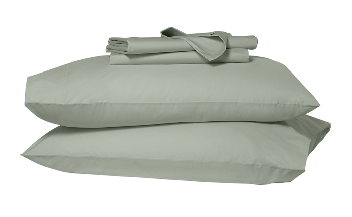 Folded sheets on top of two stacked pillows in pillowcases. Green eucalyptus colors.