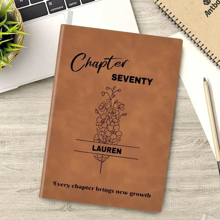 Brown leather-style journal cover with “Chapter SEVENTY” and floral tree design