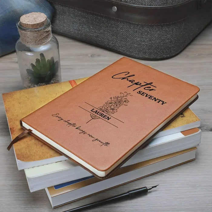 Leather-style journal in brown with “Chapter SEVENTY” and name “LAUREN”