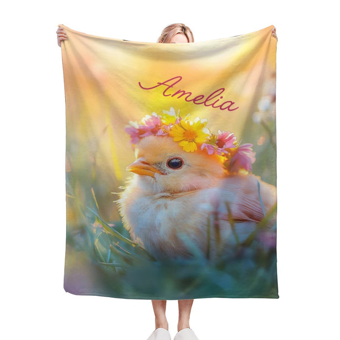Personalized blanket held up, fluffy bird with flower crown and name Amelia