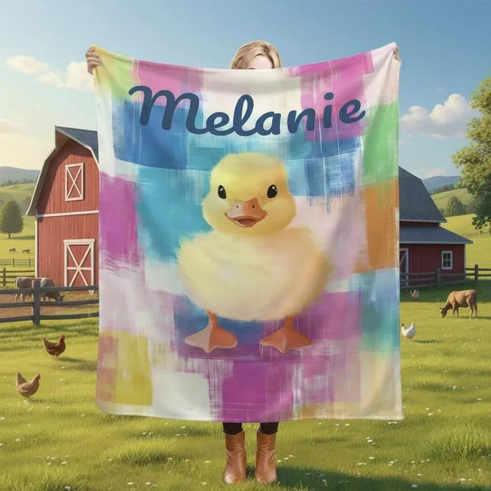 Personalized duckling blanket with colorful plaid, yellow chick design, draped outdoors