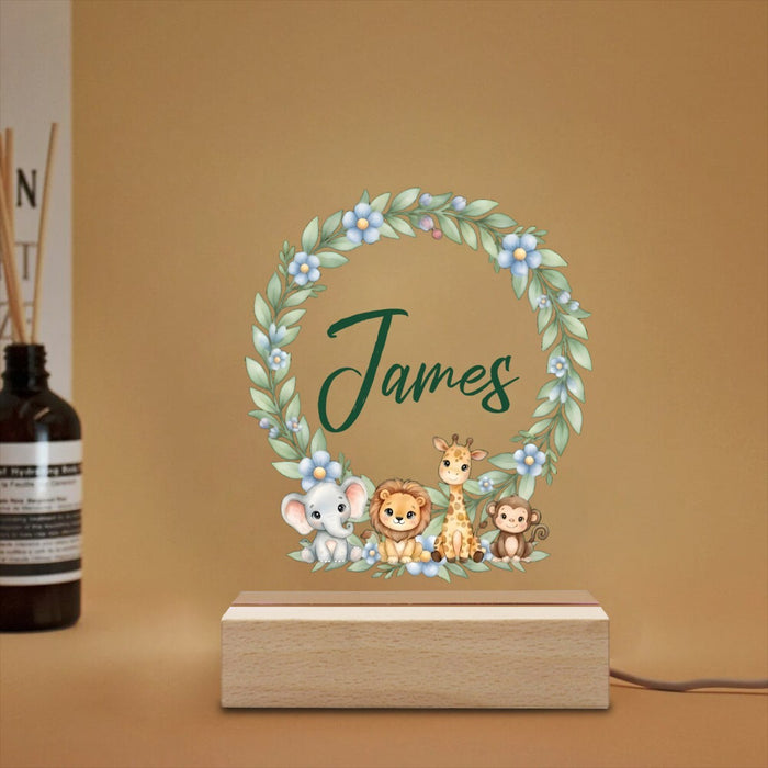 Wooden-base night light with safari wreath and custom name, angled view.