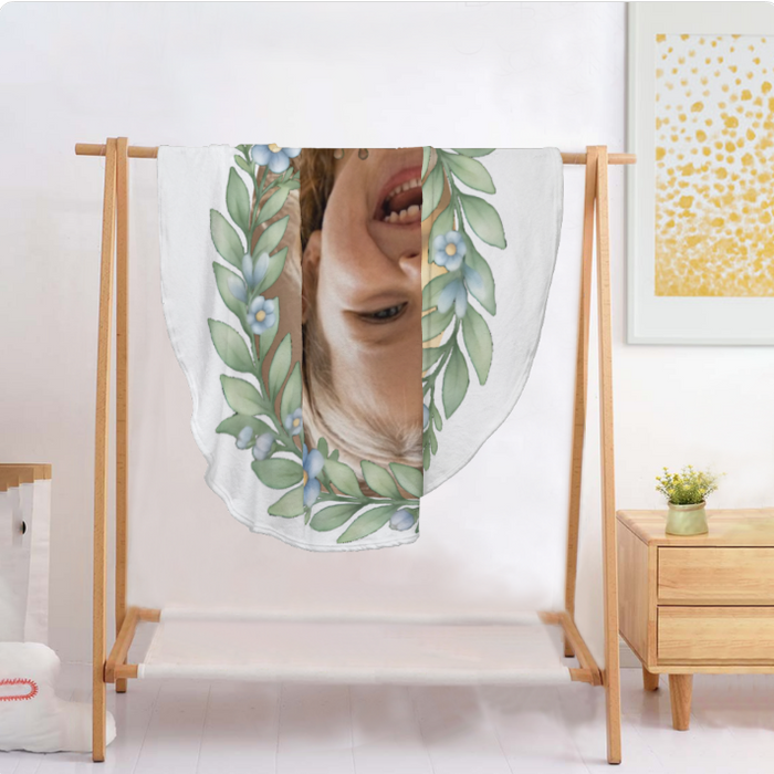 Round blanket draped on a stand, featuring safari animals, leaf border, and child photo