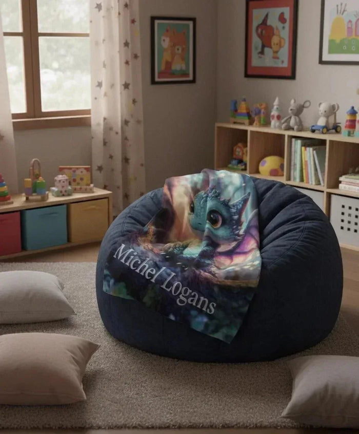 Dragon throw blanket draped on round cushion with blue dragon and name Michel Logans