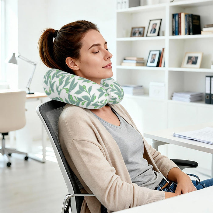 Personalized travel neck pillow with green leaf print, supporting head and neck while seated