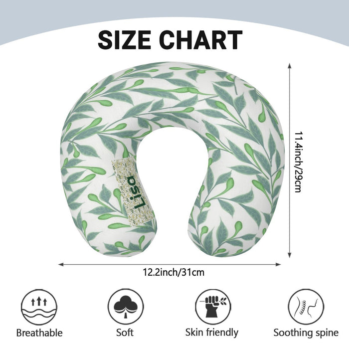 U-shaped travel neck pillow with green botanical leaf print and small labeled tag