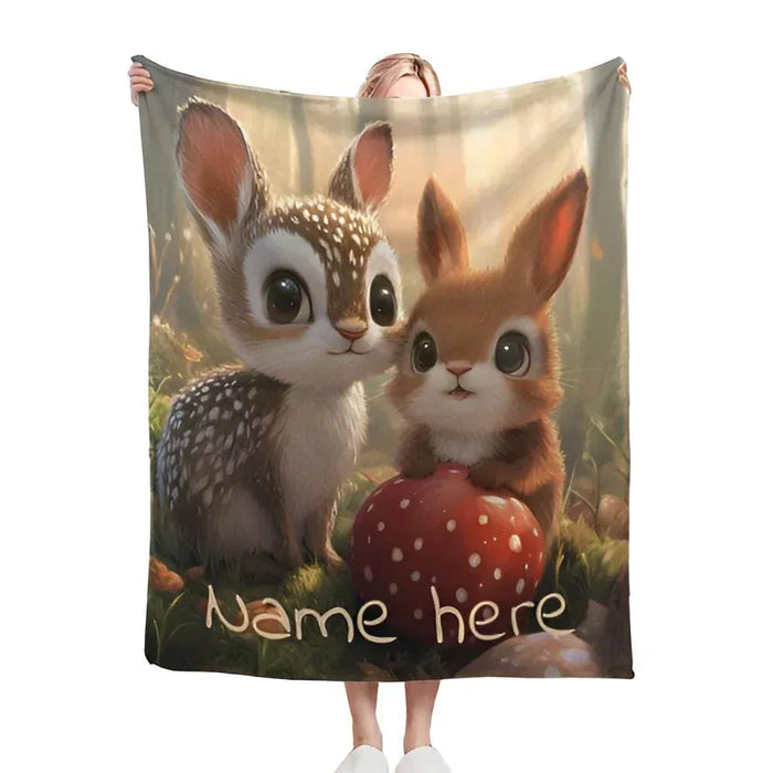 Personalized snuggle blanket with bunny and deer faces on woodland scene; “Name here”