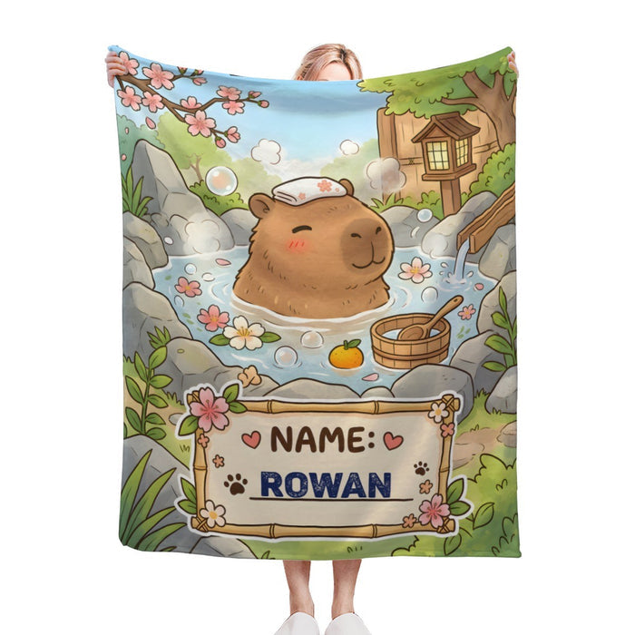 Personalized capybara hot spring blanket with custom name patch: NAME ROWAN