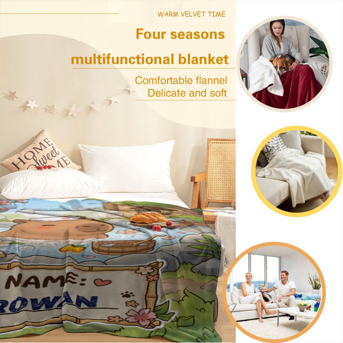 Personalized capybara hot spring blanket laid on bed, custom NAME ROWAN patch