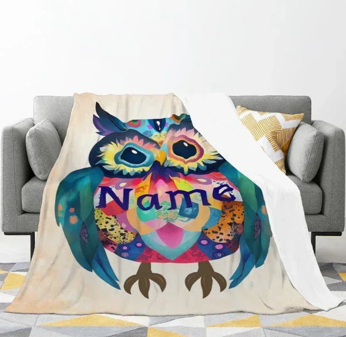Owl flannel blanket draped on sofa, with colorful owl and custom name text