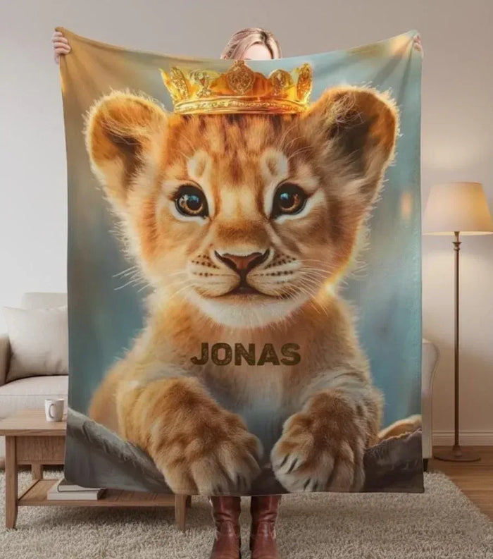 Baby lion cub blanket with crown graphic and name text "JONAS"