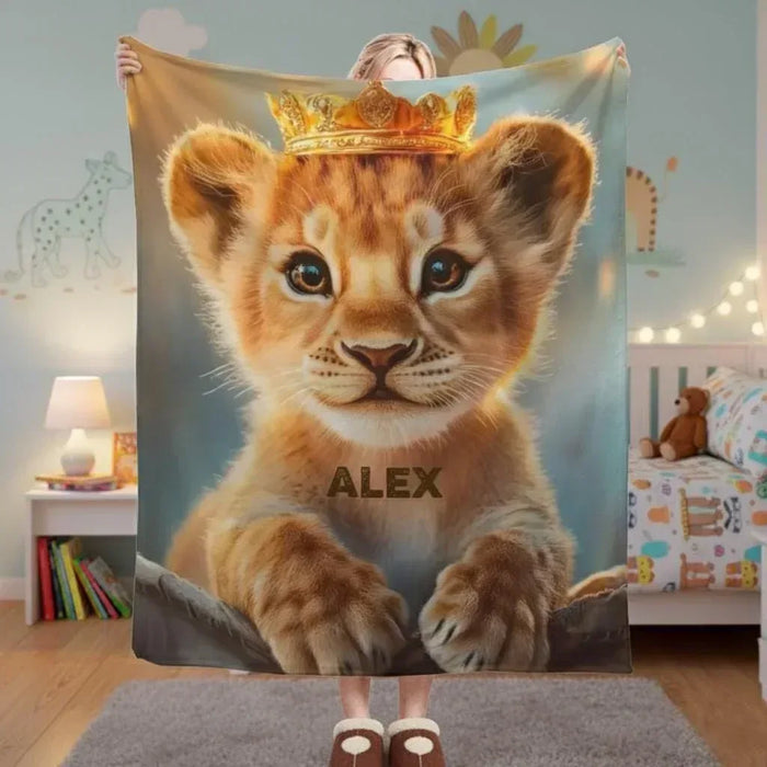 Baby lion cub blanket with crown graphic and name text "ALEX"