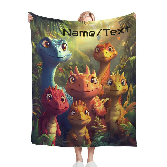 Custom dinosaur name blanket held up with dinosaur faces and Name/Text