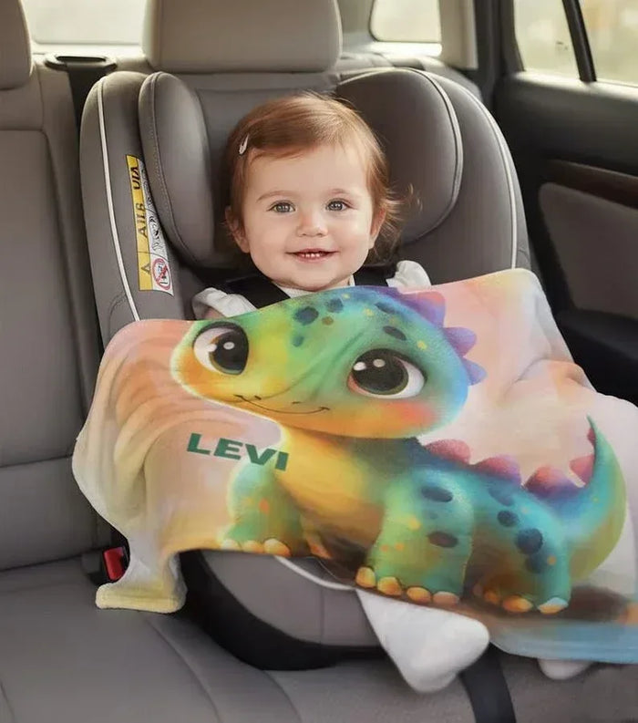 Rainbow dinosaur fleece blanket for baby with smiling green dragon and LEVI text
