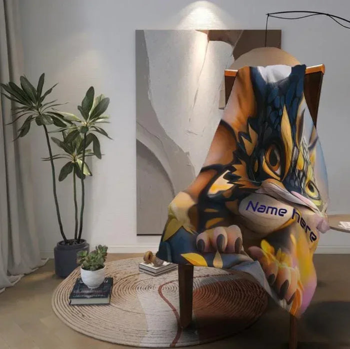 Personalized dragon flannel throw blanket draped over chair with animal-face artwork and name panel