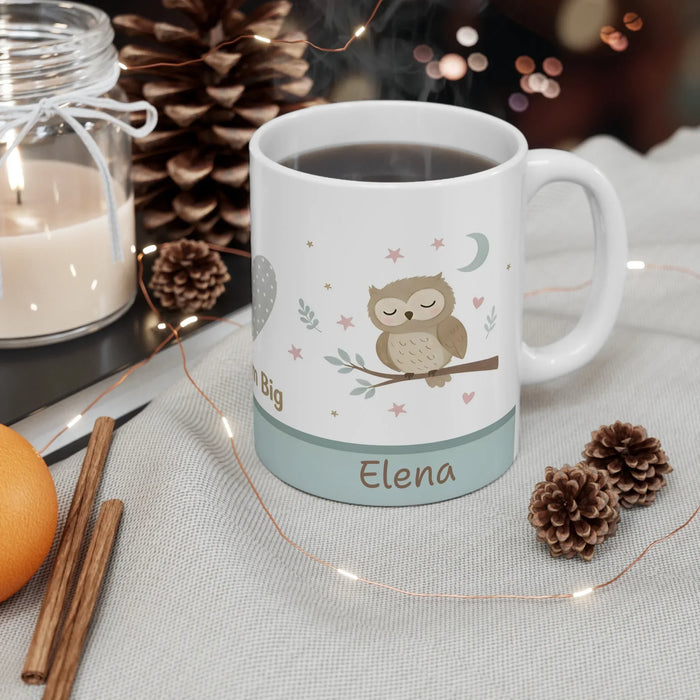 Personalized owl coffee mug with 'Elena' on teal stripe, filled with dark coffee