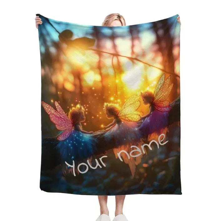 Personalized fairy throw blanket showing three winged fairies and cursive name text