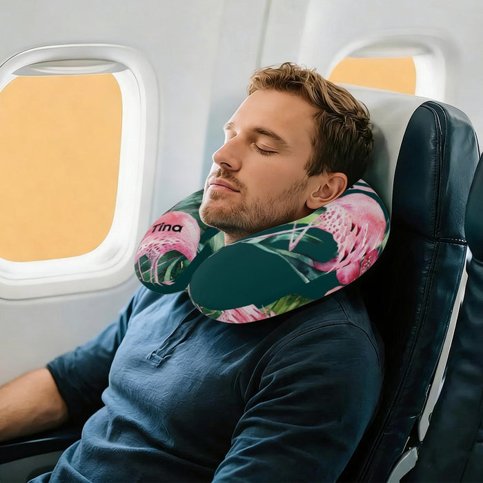 Man resting with U-shaped tropical neck pillow with flamingo print