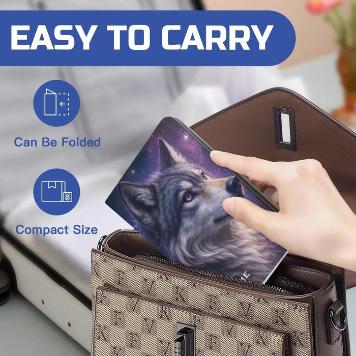 Purple galaxy wolf passport holder placed in a brown wallet pouch