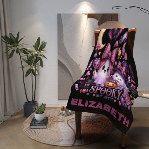 Spooky But Sweet personalized Halloween ghost blanket hanging on display