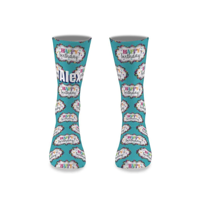 Pair of teal birthday socks with birthday cake and balloon graphics, ankle length