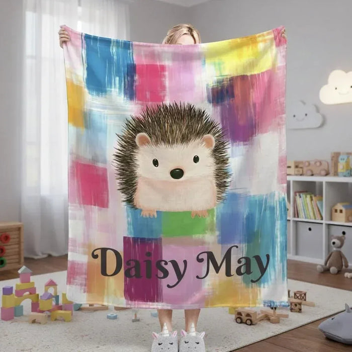 Rainbow plaid hedgehog blanket with cursive name "Daisy May" centered