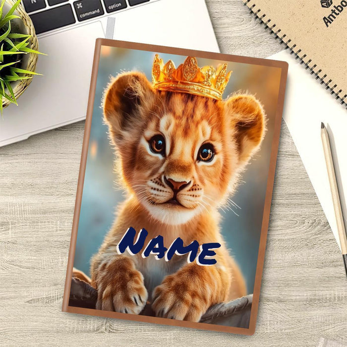 A5 notebook cover with lion cub wearing a golden crown and blue NAME text