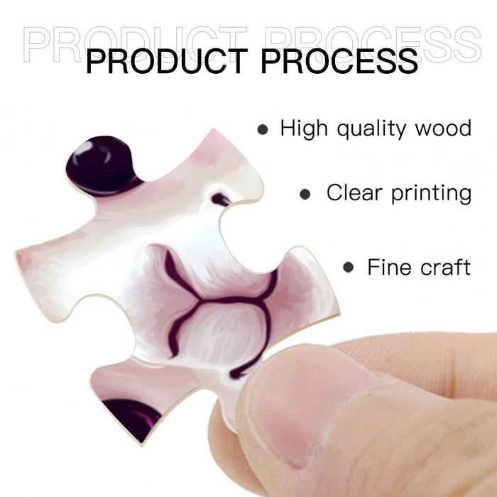 Single wooden jigsaw piece held in hand, white and purple printed design