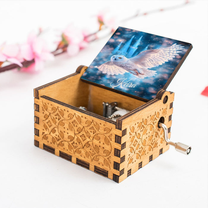 Wooden music box with blue owl lid and side winding crank handle
