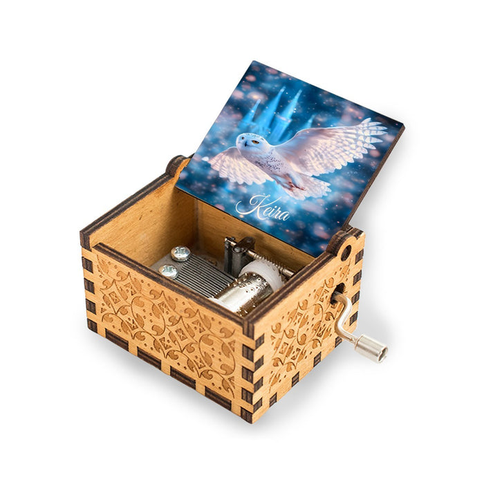 Wooden music box with blue owl artwork lid and front winding crank handle