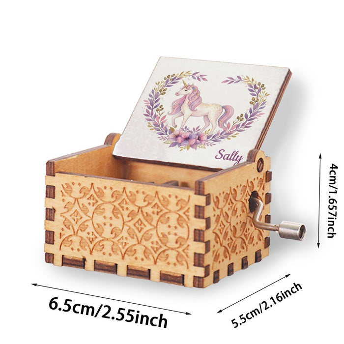 Wooden music box with open lid, unicorn illustration on lid card, silver crank on the side
