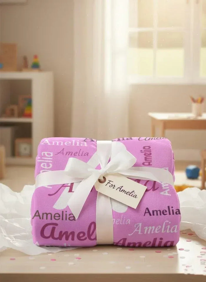 Pink and white flannel fleece personalized name blanket with ribbon bow, wrapped