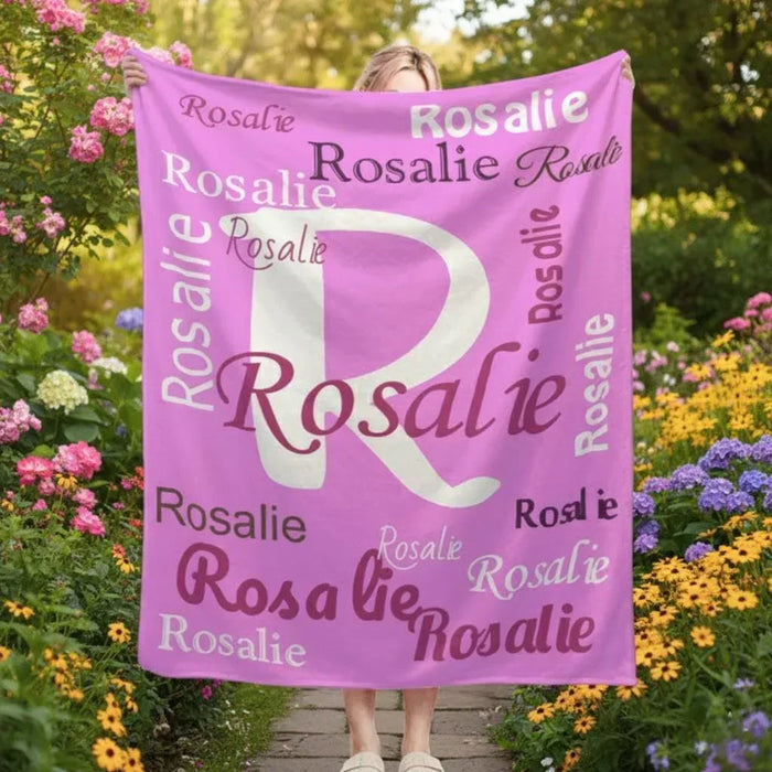 Pink fleece throw blanket with large white letter R and repeated name Rosalie